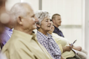 A group of people listening to a speaker