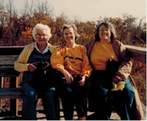 Wendy Barker sitting outside with her mother and sister 