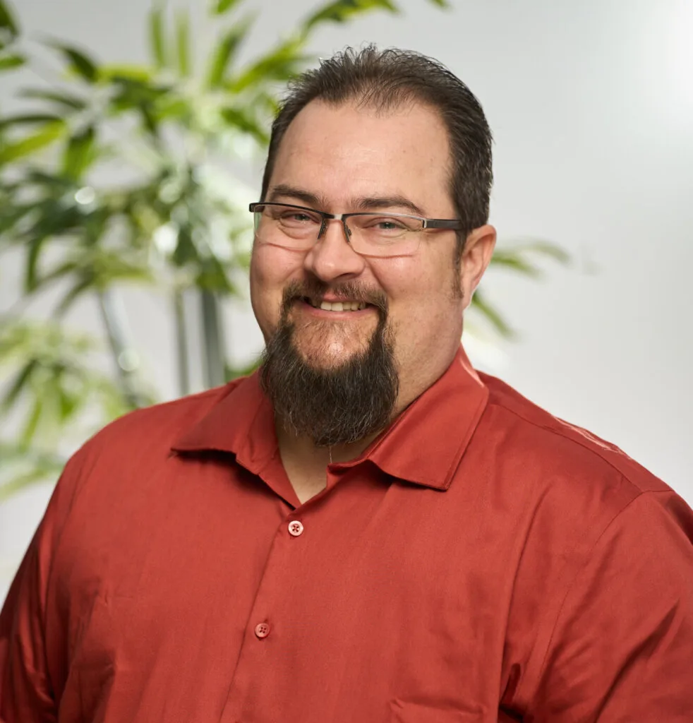 A headshot of Dan Bourrier smiling