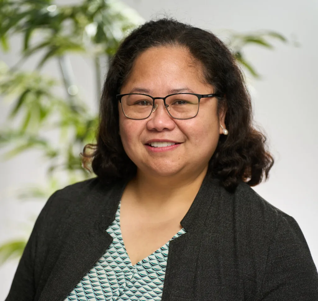 A headshot of Nerriza Bautista smiling