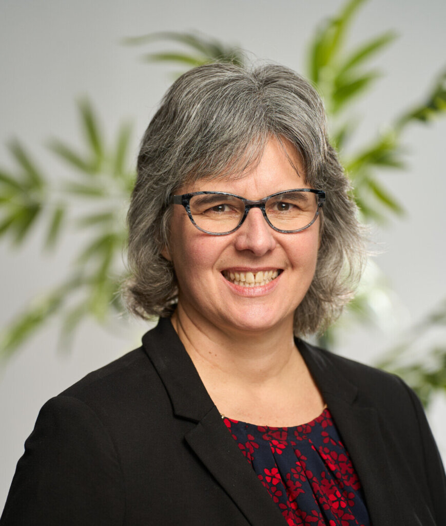 A headshot of Tracy Claeys smiling