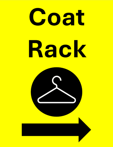 A yellow wayfinding sign with bold black letters reads: coat rack. The sign has a black arrow pointing right and there is a clothes hanger symbol in the center of the sign.