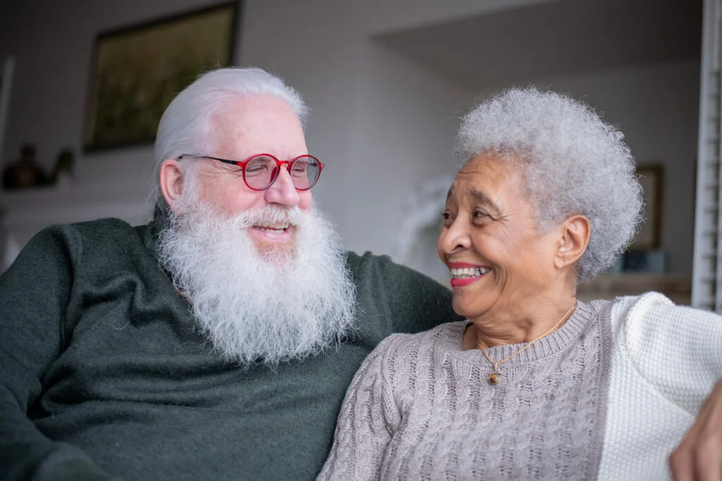 Senior man and woman smiling at each other